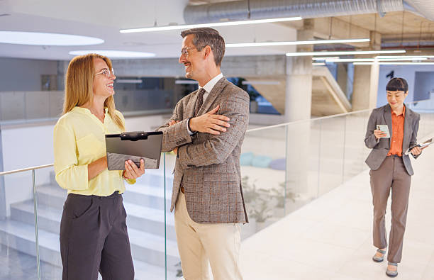 istock Business people talking and walking in modern office building hallway 2234337802