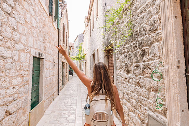 istock Joyful Woman Exploring Historic Stone Alleyway 2234338956