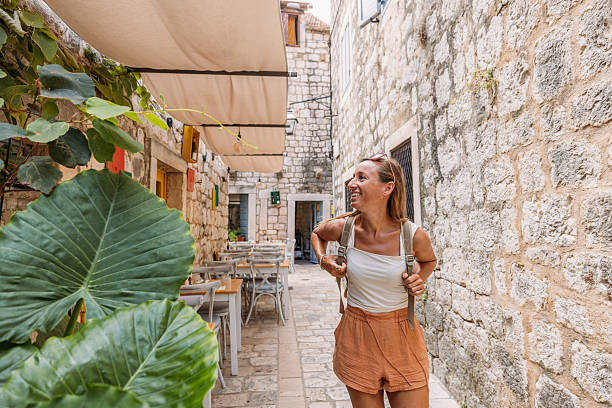 istock Woman Walking Through Charming Stone Alleyway Cafe 2234339057