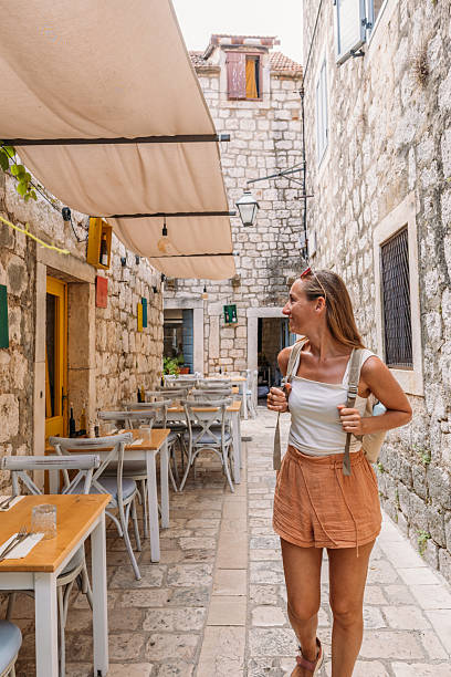 istock Woman Walking Through Charming Stone Alleyway Cafe 2234339080