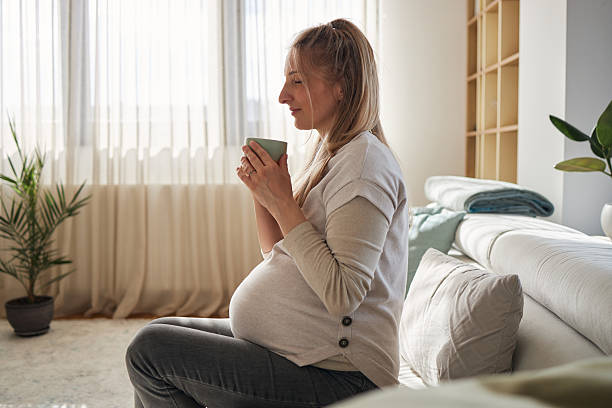 istock Happy pregnant mother enjoying her pregnancy drinking tea 2234339340