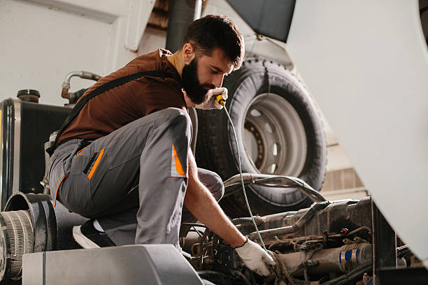 istock Auto mechanic repairing truck engine in garage 2234340739