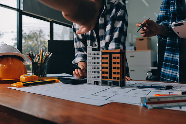 istock Construction and structure concept of engineer working drawing on blueprint meeting for project working with partner on model building and engineering tools in working site, construction concept. 2234341625