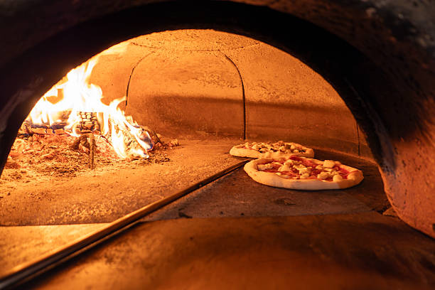 istock Traditional Wood-Fired Pizza Baking in Rustic Brick Oven 2234342180