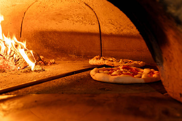istock Traditional Wood-Fired Pizza Baking in Rustic Brick Oven 2234342292