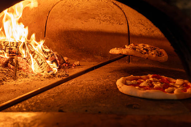 istock Traditional Wood-Fired Pizza Baking in Rustic Brick Oven 2234342328