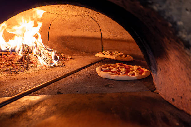 istock Traditional Wood-Fired Pizza Baking in Rustic Brick Oven 2234342410