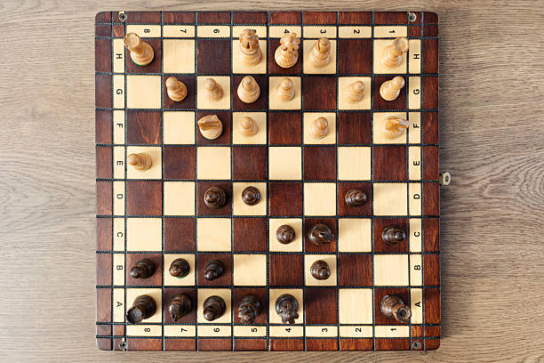 istock Wooden chessboard with pieces, top view. 2234343227