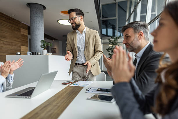 istock Business team applauding a colleague after successful presentation in modern office 2234343885