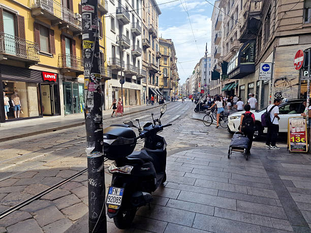 Milan, Italy - June 15, 2025: a view of Via Torino, Milan's international shopping street, with crowds of shoppers and tourists