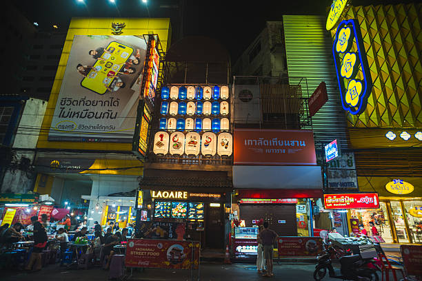A night life scene at Chinatown, Bangkok, captures the lively energy of the district with neon signs glowing above crowded streets. Street food vendors, bustling markets, and streams of locals and tourists create a vibrant atmosphere, blending traditional flavors with the modern pulse of the city after dark.