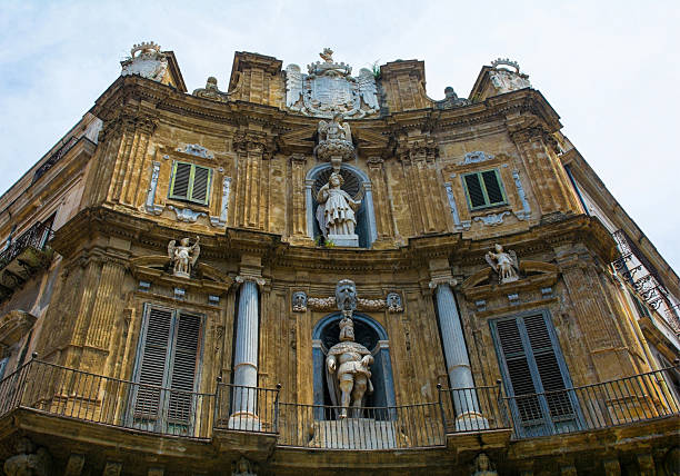 Mid-adult man making a finger heart in front of the Palermo Cathedral in Palermo in Sicily.