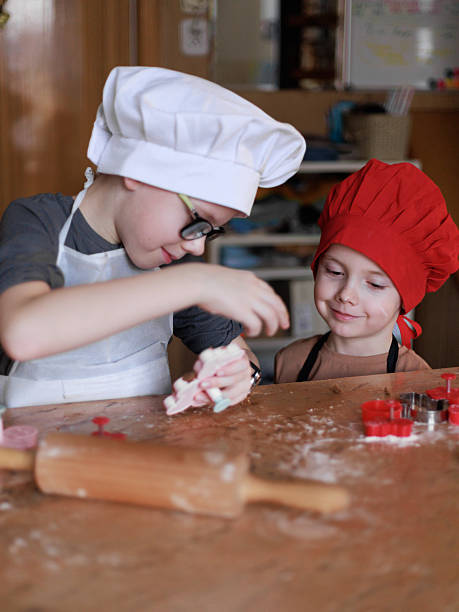istock Brothers creating Christmas cookies 2234350187