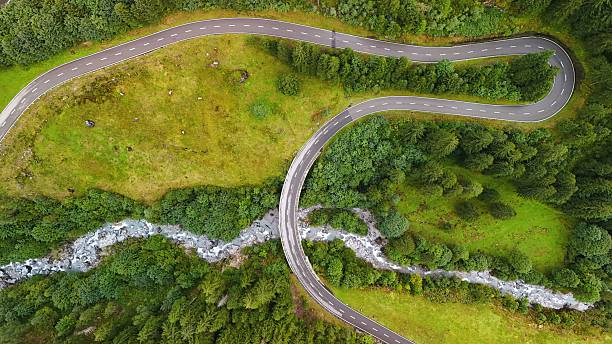 istock Winding Mountain Road Through Lush Forest – Aerial View 2234350648