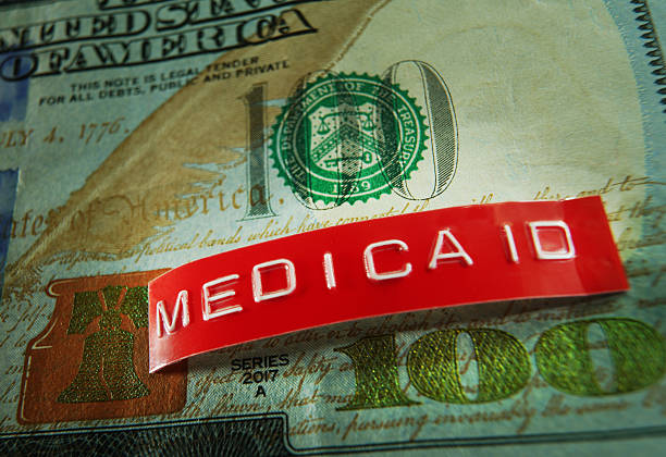 istock Red Medicaid label closeup on a US hundred dollar bill -- budget cuts 2234352561