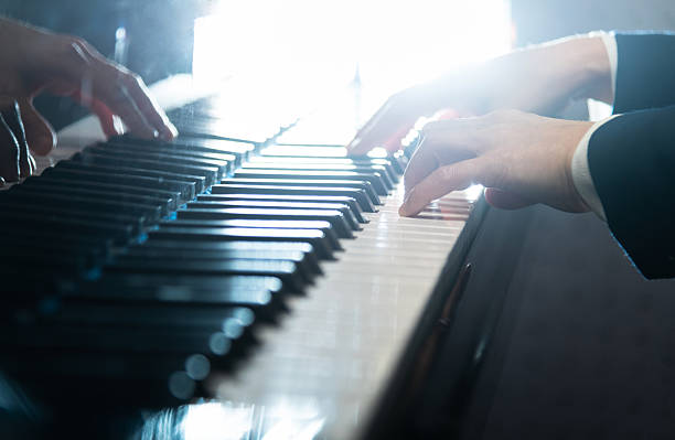 istock Woman's hands playing the piano 2234352771