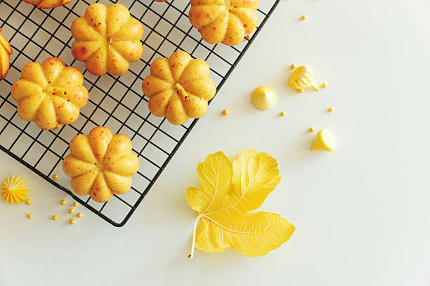 istock Autumn-Themed Mini pumpkin Cakes with Seasonal Decorations on White Background 2234355127