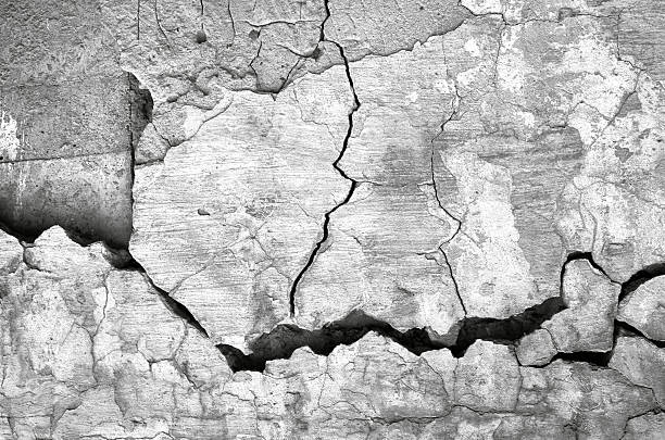 Texture cracked ruined gray wall background with grunge plaster, full frame