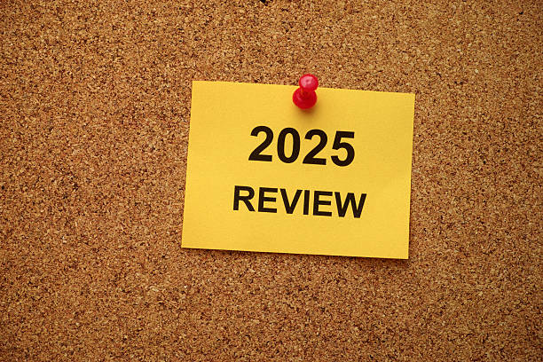 istock A yellow paper note with the text 2025 Review on it pinned to a cork board. 2234363719