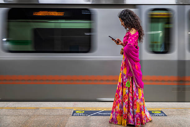 istock Indian girl using a mobile phone at metro station, India 2234365654