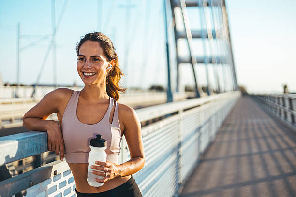 istock Young Woman Smiling After Outdoor Activity on a Modern Bridge 2234365743