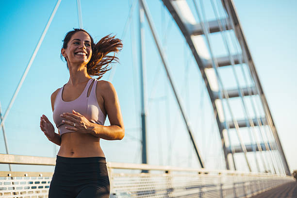 istock Smiling Woman Jogging on a Bridge During a Sunny Morning 2234365765
