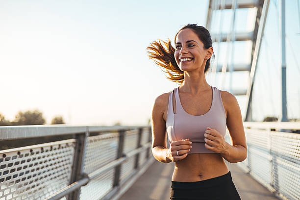 istock Woman Jogging on a Bridge in the Morning Sunlight 2234365767
