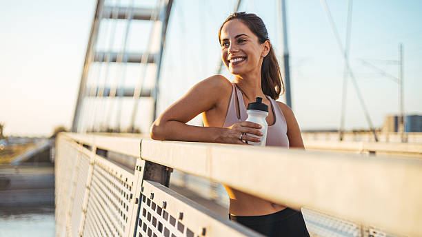 istock Smiling Woman Resting on a Modern Bridge After a Productive Workout 2234365783
