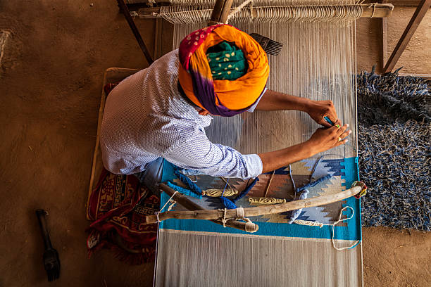 istock Indian man weaving textiles (durry) in Rajasthan 2234365950