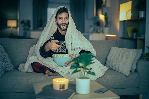 istock Cozy evening at home with popcorn and a movie while wrapped in a blanket 2234367557