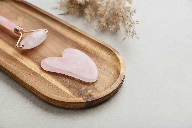 istock Facial rose quartz stone massage roller and gua sha massager 2234369381