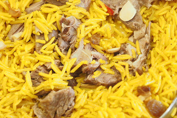 A flavorful dish featuring long-grain yellow rice mixed with tender meat.