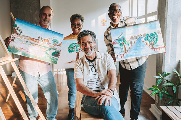 istock Teacher and senior students displaying paintings 2234378858