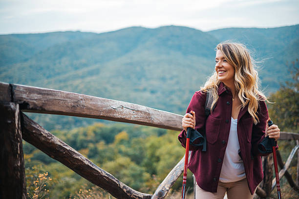 istock Beautiful mountains, standing young woman with backpack on the peak at sunset 2234379621