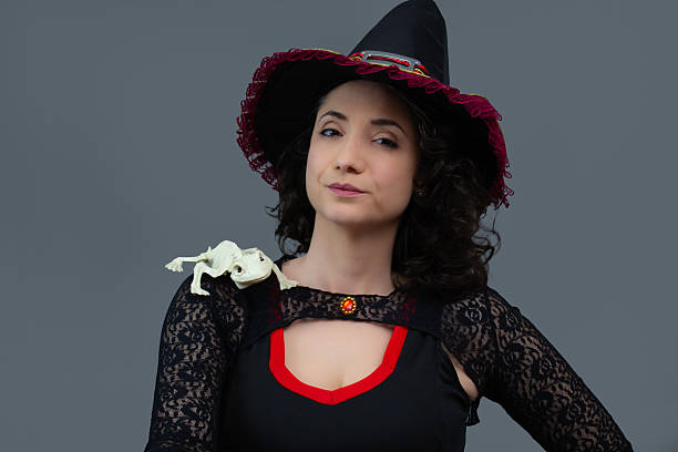 istock Beautiful witch with pet frog skeleton on her shoulder. 2234381017