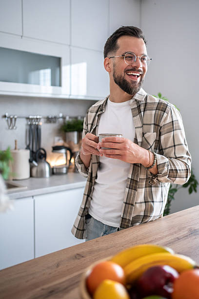 istock Happy young man drinking coffee in a modern kitchen 2234383350
