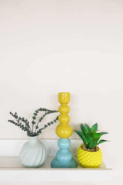 istock Decorative vases and candle holder on a shelf in bright colors 2234383434