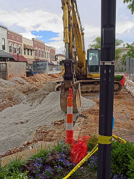istock Construction excavator leveling gravel on city street project 2234384652