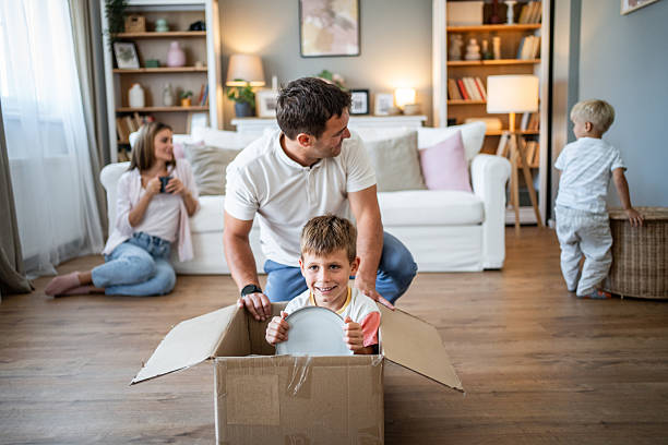 istock Family having fun while unpacking boxes in new home 2234385488
