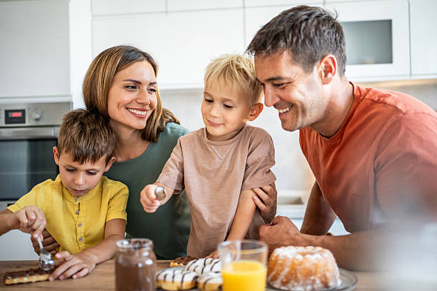 istock Happy family preparing breakfast in the kitchen 2234385611