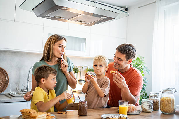 istock Happy family enjoying breakfast together in modern kitchen 2234385692