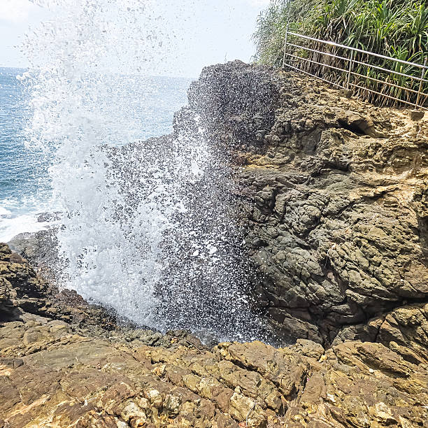 istock Powerful ocean waves crash against rugged coastal rocks, creating white foam under a bright sky. A dramatic seascape capturing the untamed beauty, energy, and strength of nature. 2234386421