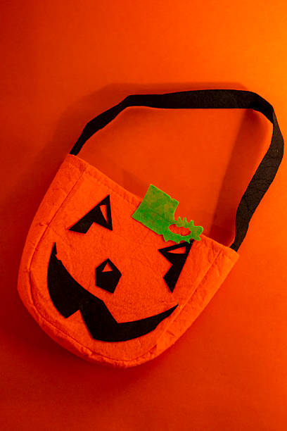 Orange Jack-O'-Lantern Halloween Bag Against Matching Dramatic Background