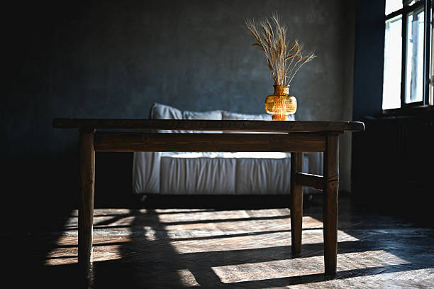 istock Wooden table with wheat in vase in a room 2234390588