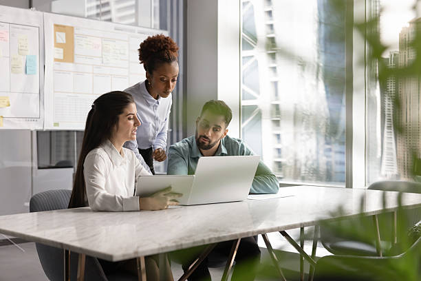 istock Colleagues take part in briefing using laptop and digital tablet 2234396350