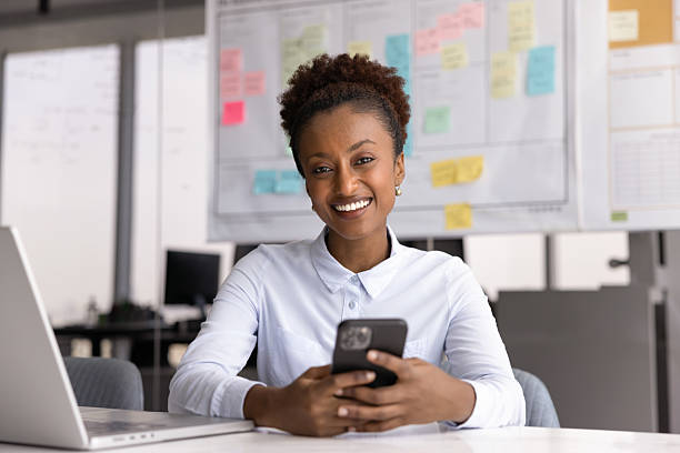 istock Woman holding smart phone looking at camera 2234400251