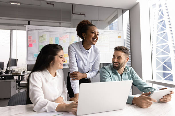 istock Group of laughing teammates engaged in positive communication in workplace 2234400943