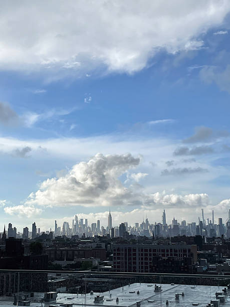 istock New York City skyline with fluffy clouds and blue sky 2234403087