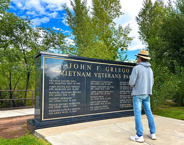 Santa Fe, NM - June 1, 2025: A man reading the Vietnam Veterans wall in the John F. Griego Park along the Santa Fe River, west of downtown.