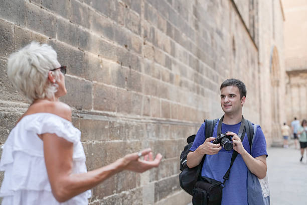 istock A man with a camera is talking to a woman 2234406384